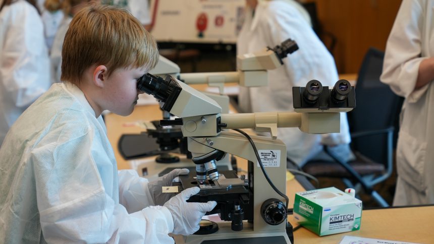 Child Looking Through Microscope