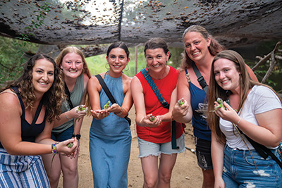 students holding geckos