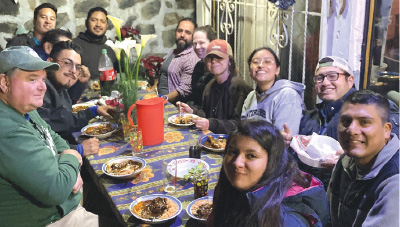 Dr. Schott eating with people in Mexico