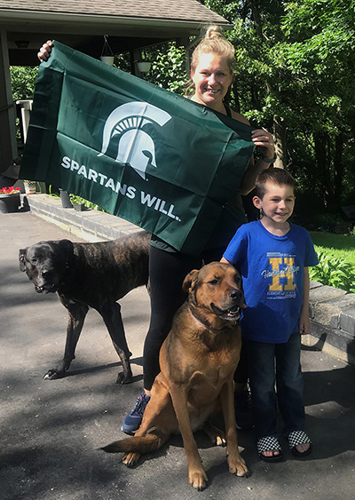 Talley-Woychowski and her son pose with their two dogs. 